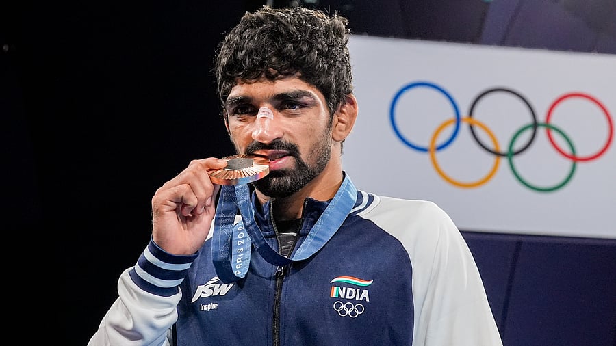 <div class="paragraphs"><p>Bronze medalist India’s Aman Sehrawat poses for photos during the medal ceremony.</p></div>